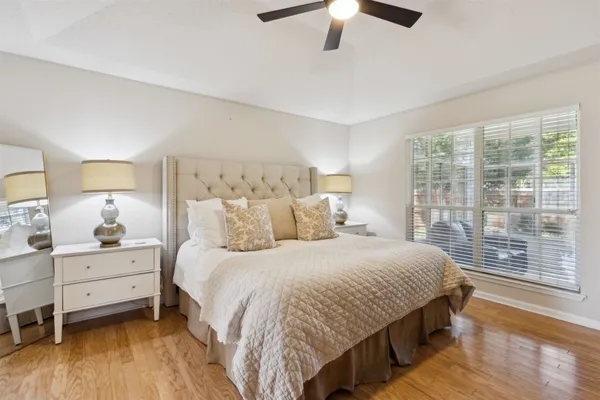 a living room with furniture and a ceiling fan