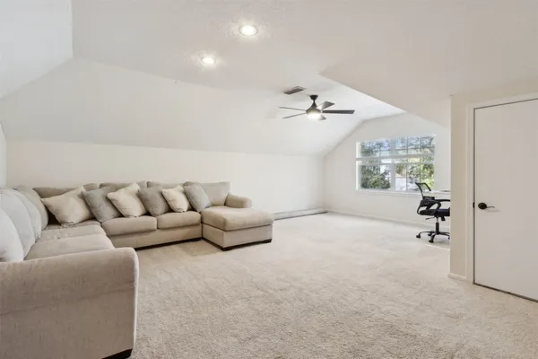 a living room with furniture and a floor to ceiling window