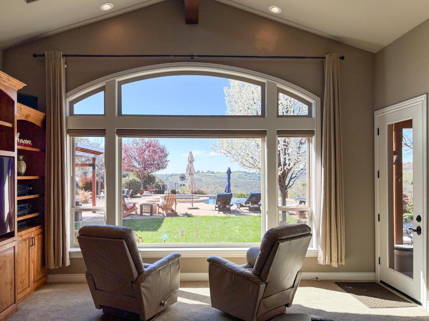 2920 Martel Creek Road Rescue, CA 95672 - Photo 13 of 69 a living room with furniture and a floor to ceiling window