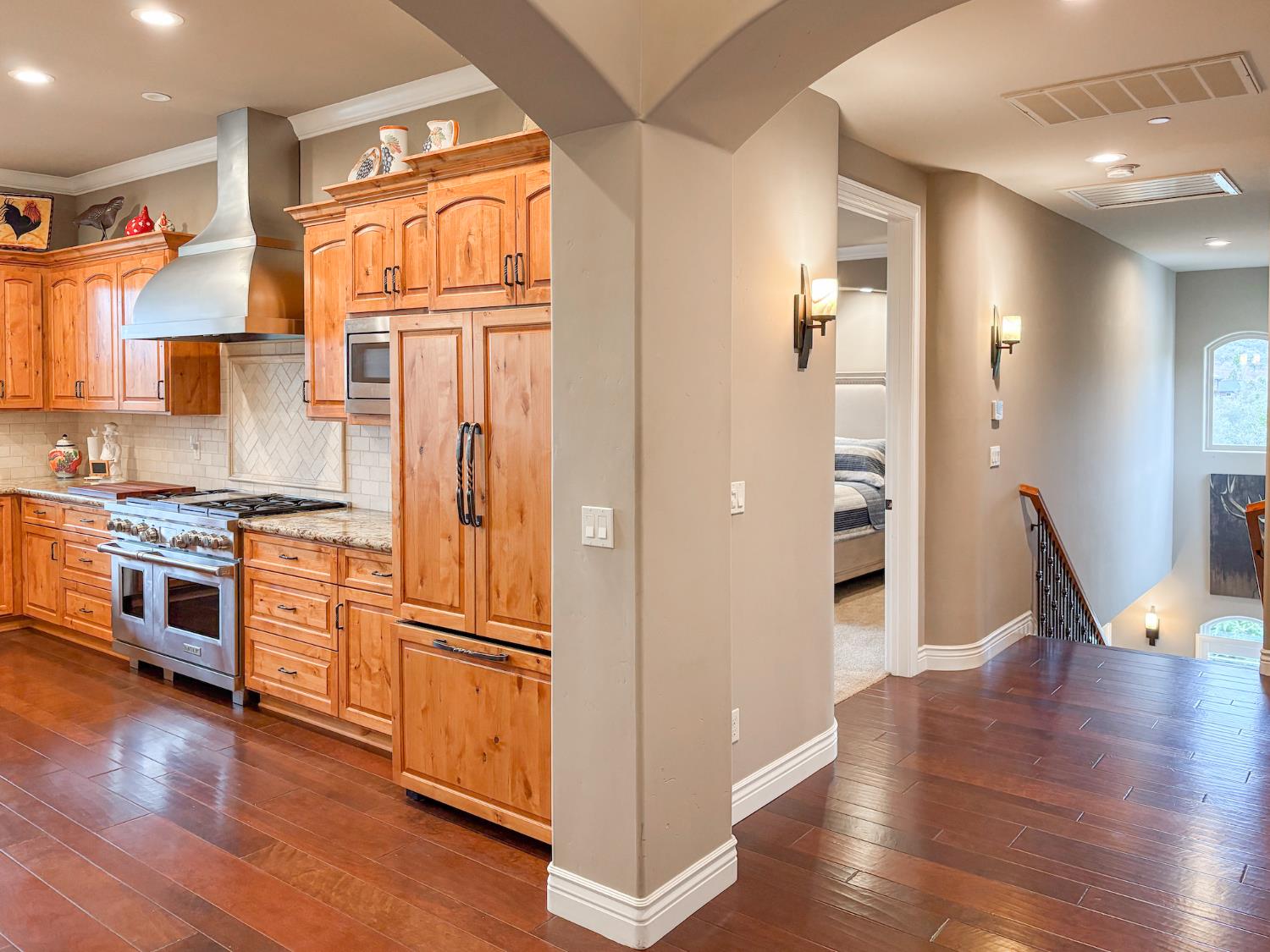 2920 Martel Creek Road Rescue, CA 95672 - Photo 21 of 69 a kitchen with stainless steel appliances granite countertop a refrigerator a stove and a wooden floors
