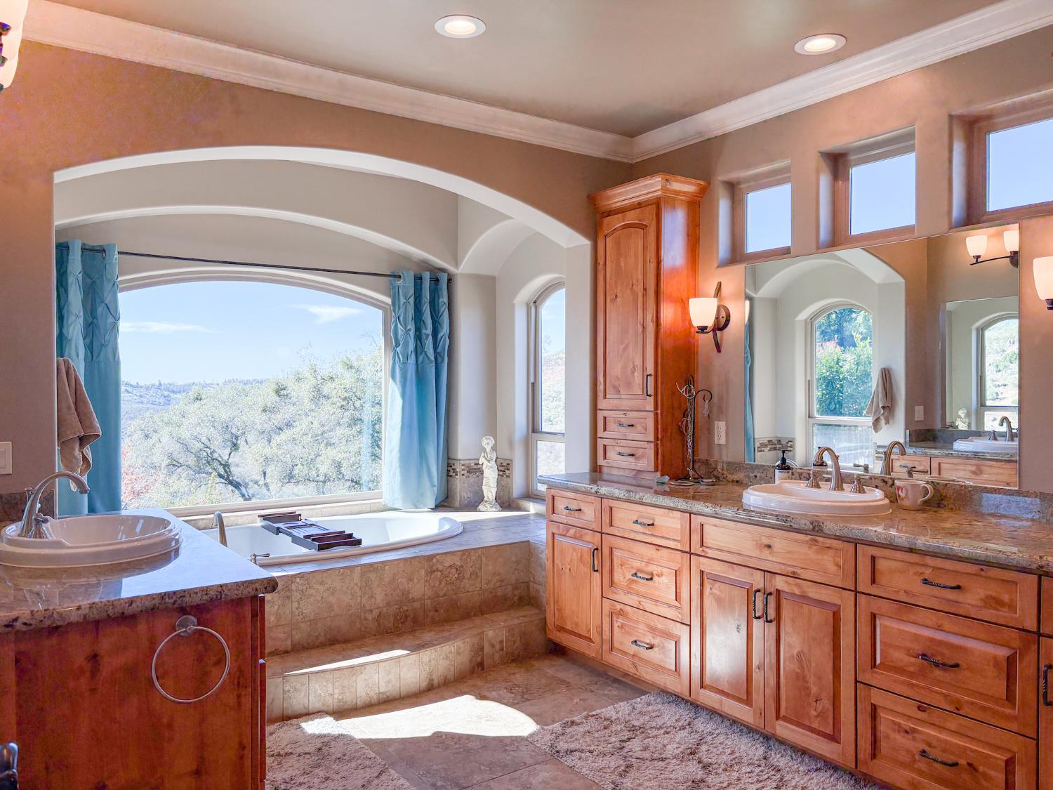 2920 Martel Creek Road Rescue, CA 95672 - Photo 26 of 69 a large bathroom with a granite countertop sink and a large mirror