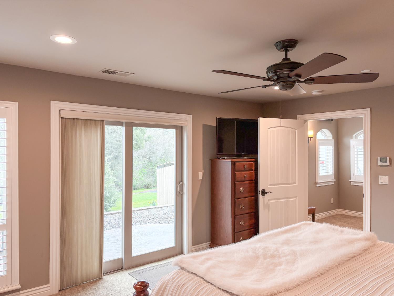 2920 Martel Creek Road Rescue, CA 95672 - Photo 37 of 69 a bed room with a bed and a chandelier