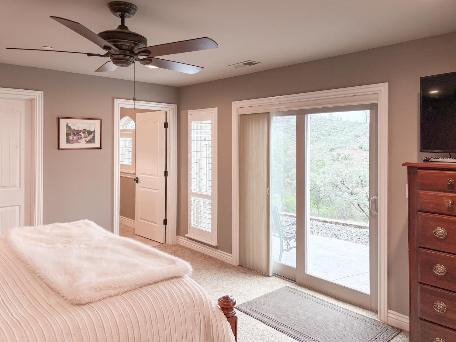 2920 Martel Creek Road Rescue, CA 95672 - Photo 38 of 69 a bedroom with a bed and a chandelier