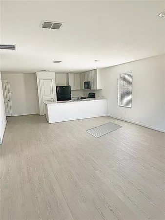 a kitchen with stainless steel appliances a sink stove refrigerator and cabinets