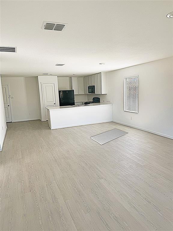 1271 Falcon Hts Drive Forney, TX 75126 - Photo 8 of 29 Unfurnished living room with light wood-style flooring and baseboards