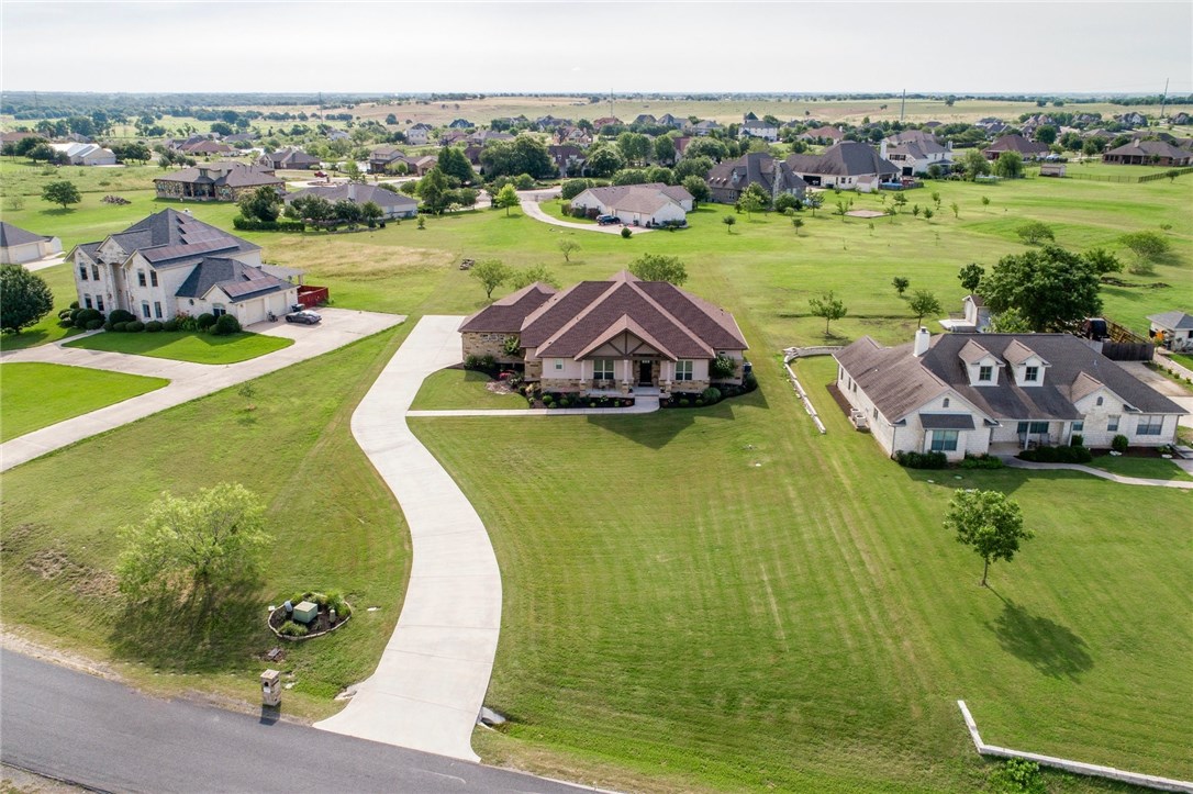 136 Tonkawa Ridge Hutto, TX 78634 - Photo 1 of 1 a view of a lake with a building in the background