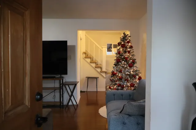 a living room with furniture and a wooden floor