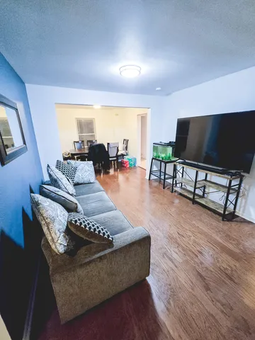 a white toilet sitting next to a shower curtain and a sink