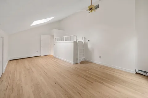 a view of a room with wooden floor