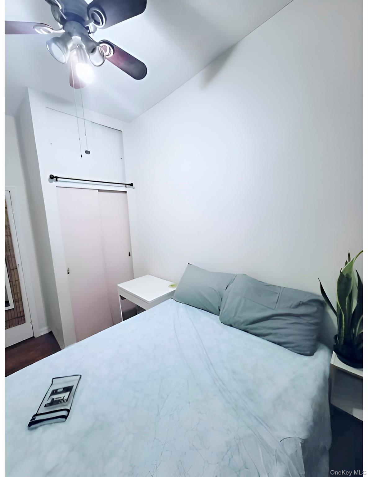 324 East 50th Street, Unit 3A Manhattan, NY 10022 - Photo 5 of 13 a bedroom with a bed and a chandelier