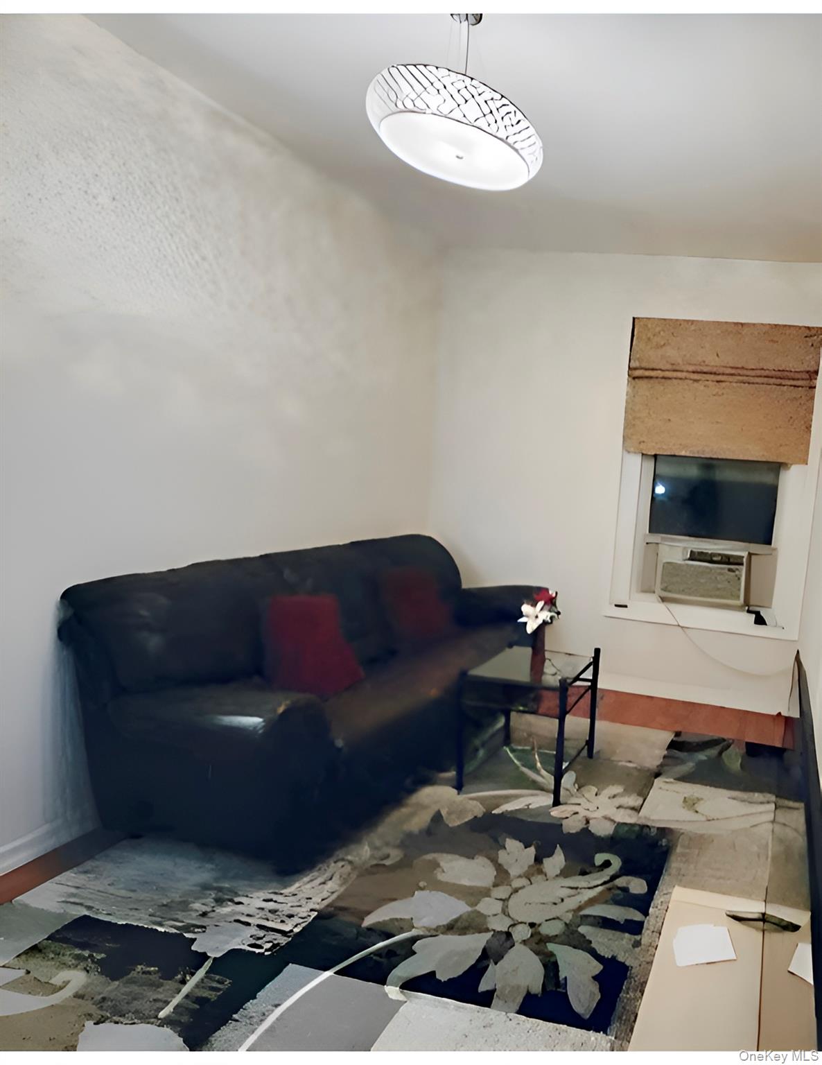 324 East 50th Street, Unit 3A Manhattan, NY 10022 - Photo 7 of 13 a living room with furniture and a rug