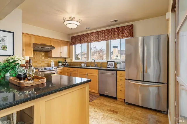 a kitchen with a refrigerator and a sink