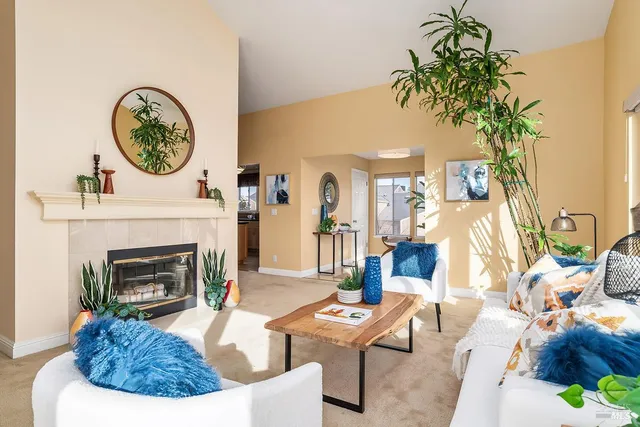a living room with furniture a clock and a fireplace