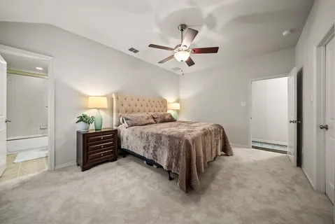 a bedroom with a bed and ceiling fan