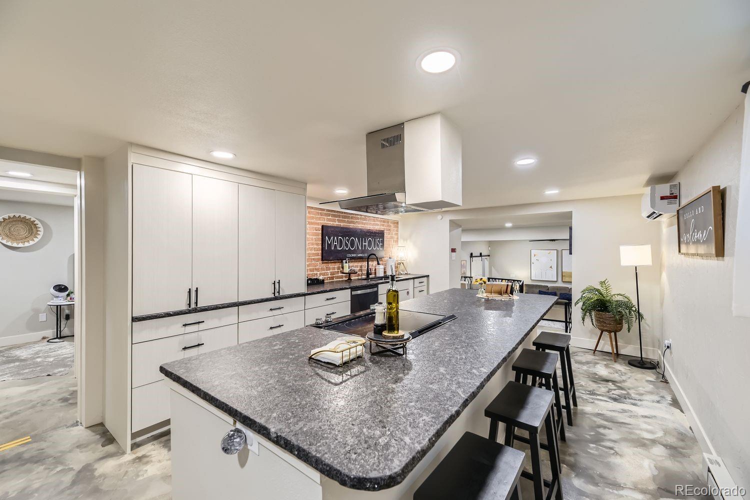 2132 North Nevada Avenue Colorado Springs, CO 80907 - Photo 12 of 26 a kitchen with kitchen island a sink table and chairs