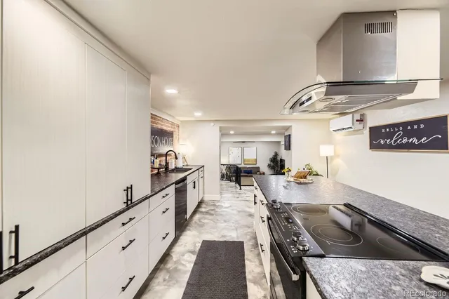 a kitchen with sink stove and cabinets