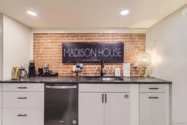 a kitchen with stainless steel appliances granite countertop a sink and a window
