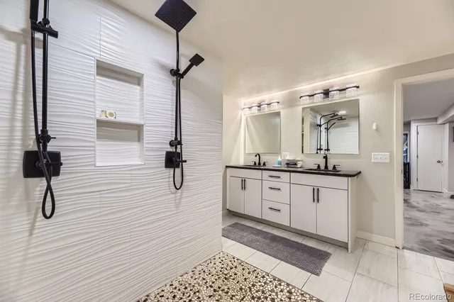 a bathroom with a sink a mirror and shower