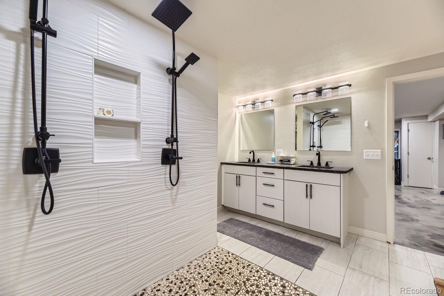 2132 North Nevada Avenue Colorado Springs, CO 80907 - Photo 20 of 26 a bathroom with a sink a mirror and shower