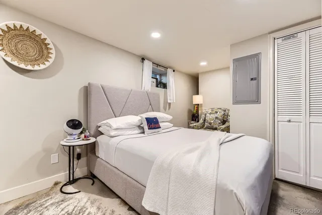 a bed room with a bed and a lamp