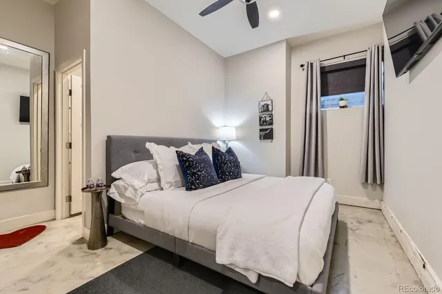 a bedroom with bed and a tv