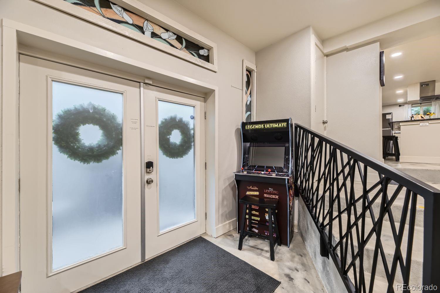 2132 North Nevada Avenue Colorado Springs, CO 80907 - Photo 6 of 26 a view of a hallway with wooden floor and staircase