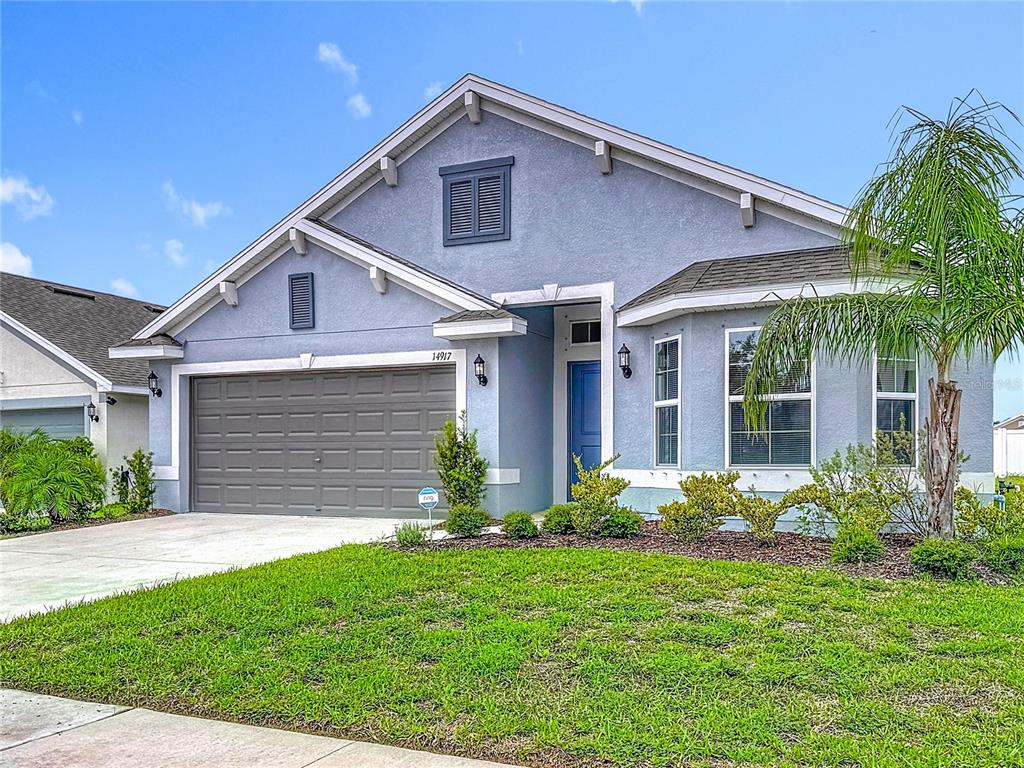 14917 Tropical Violet Way Wimauma, FL 33598 - Photo 2 of 77 a front view of a house with garden