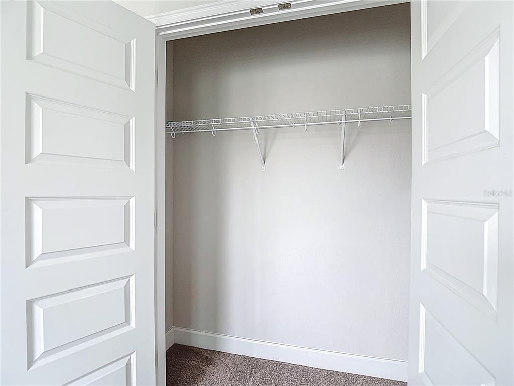 14917 Tropical Violet Way Wimauma, FL 33598 - Photo 40 of 77 a view of an empty walk in closet
