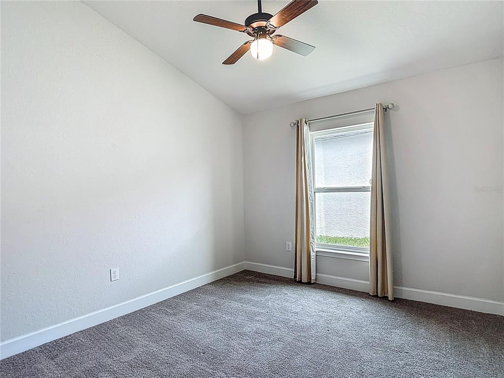 14917 Tropical Violet Way Wimauma, FL 33598 - Photo 43 of 77 an empty room with windows and closet