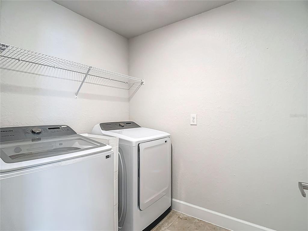 14917 Tropical Violet Way Wimauma, FL 33598 - Photo 47 of 77 a utility room with dryer and washer