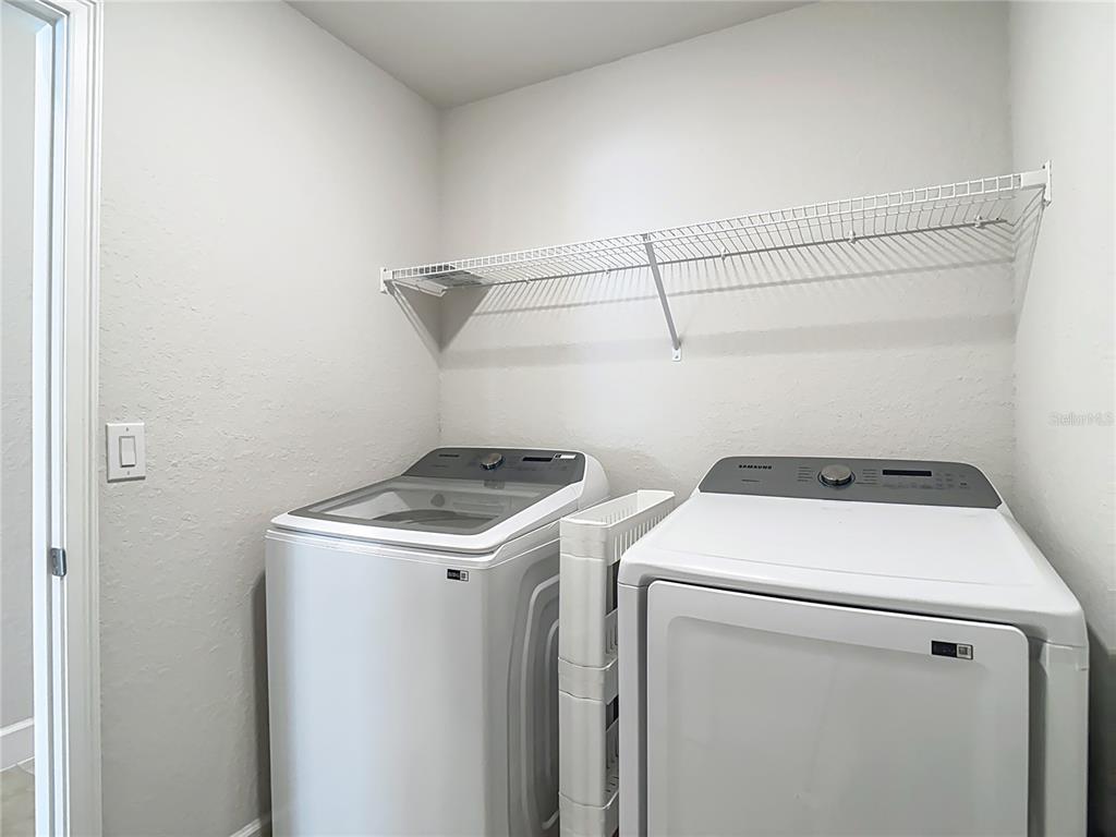14917 Tropical Violet Way Wimauma, FL 33598 - Photo 48 of 77 a utility room with dryer and washer