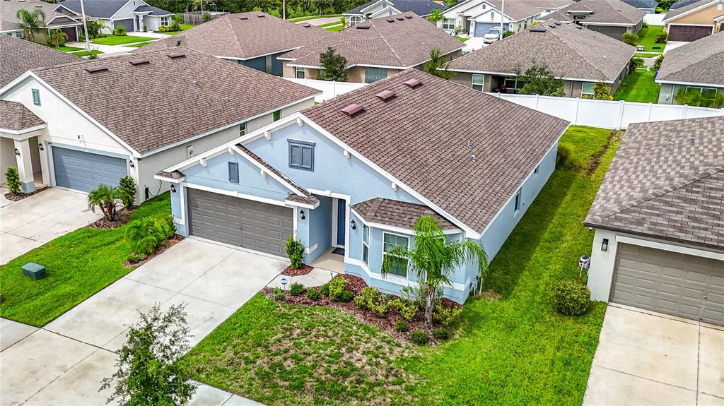 14917 Tropical Violet Way Wimauma, FL 33598 - Photo 5 of 77 an aerial view of a house with a yard table and chairs