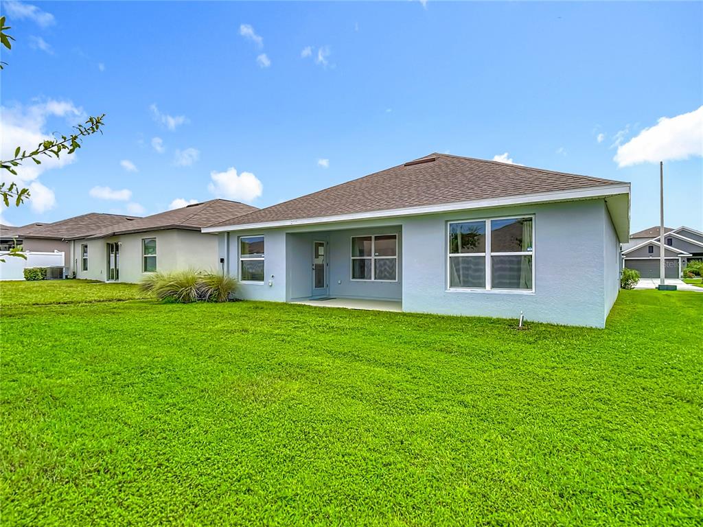 14917 Tropical Violet Way Wimauma, FL 33598 - Photo 56 of 77 a front view of a house with a garden