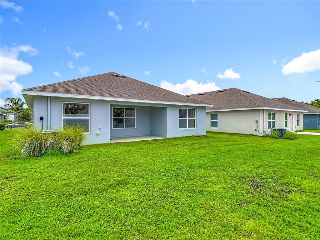 14917 Tropical Violet Way Wimauma, FL 33598 - Photo 57 of 77 a front view of a house with a garden