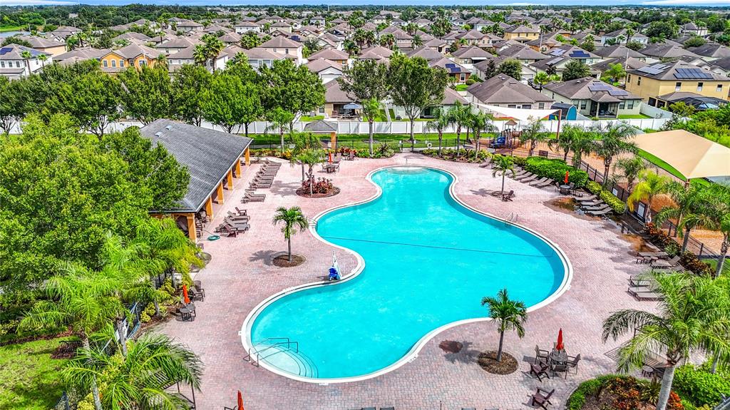 14917 Tropical Violet Way Wimauma, FL 33598 - Photo 69 of 77 an aerial view of a swimming pool a yard and lake view