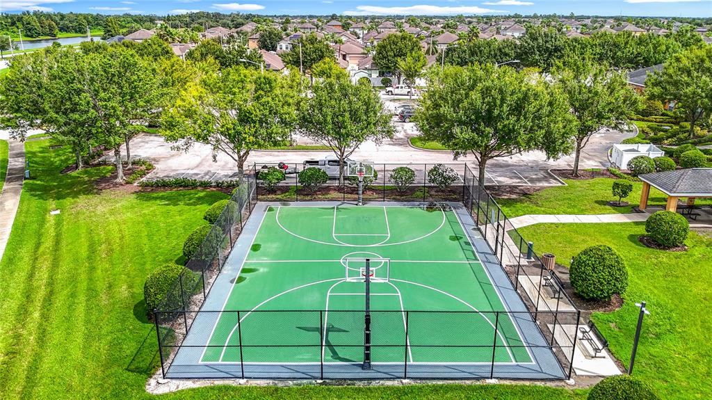 14917 Tropical Violet Way Wimauma, FL 33598 - Photo 71 of 77 a view of a tennis ground with large trees