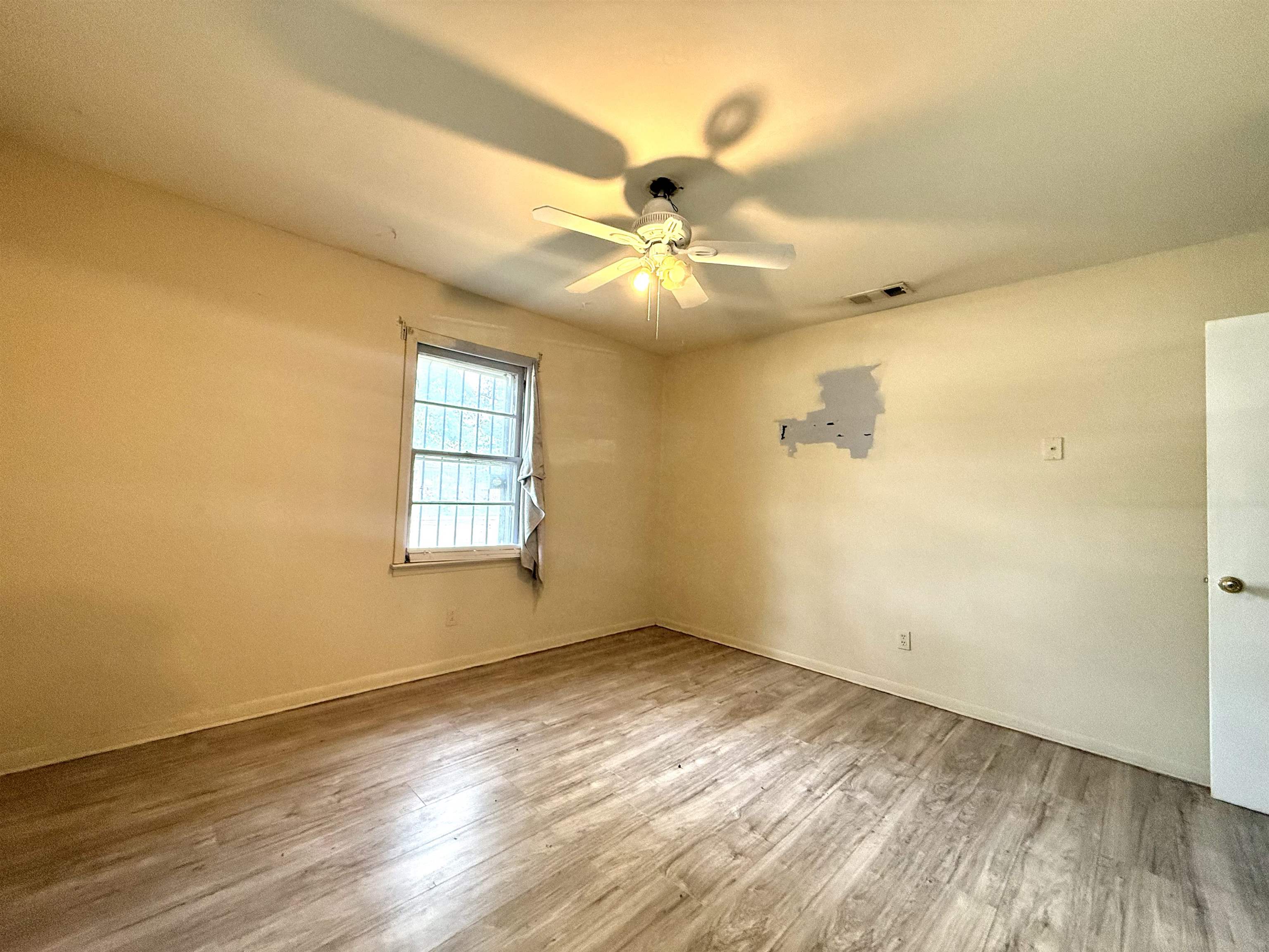 2930 Getwell Road Memphis, TN 38118 - Photo 9 of 25 Room featuring wood-finish flooring, a ceiling fan with integrated lighting, and light-toned walls