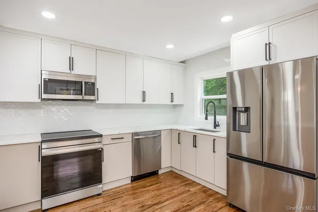a kitchen with a refrigerator sink and microwave
