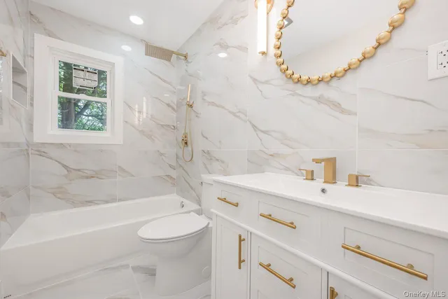 a bathroom with a sink a toilet and a bathtub