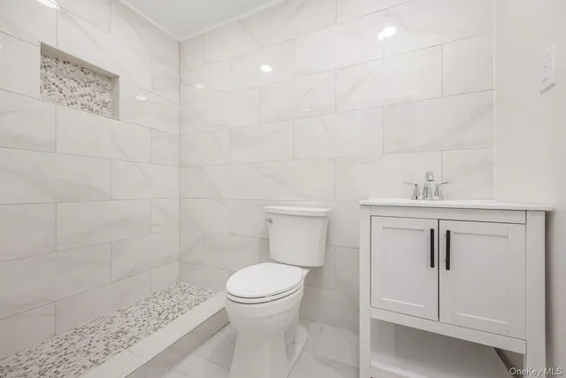a bathroom with a toilet sink and shower