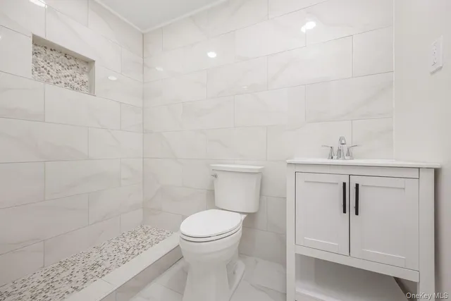 a bathroom with a toilet sink and shower