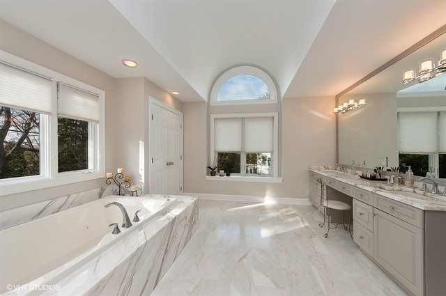 920 Bluff Street Glencoe, IL 60022 - Photo 13 of 29 a spacious bathroom with a granite countertop tub mirror and double vanity