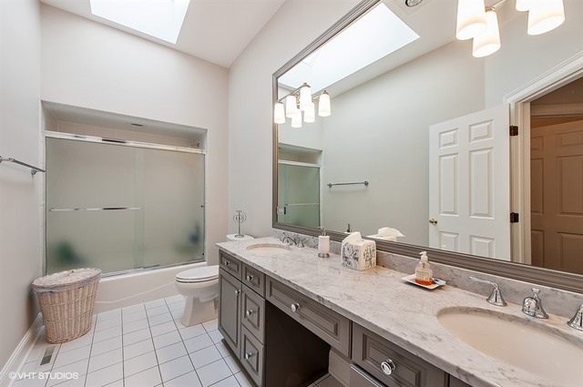 920 Bluff Street Glencoe, IL 60022 - Photo 15 of 29 a bathroom with a granite countertop sink toilet and shower