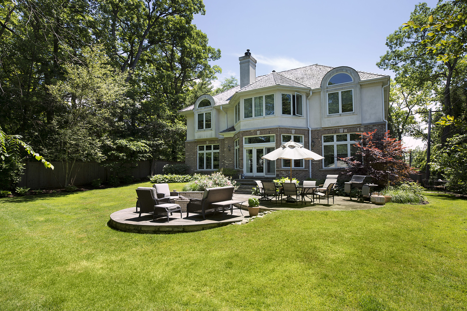 920 Bluff Street Glencoe, IL 60022 - Photo 26 of 29 a front view of a house with sitting area and garden