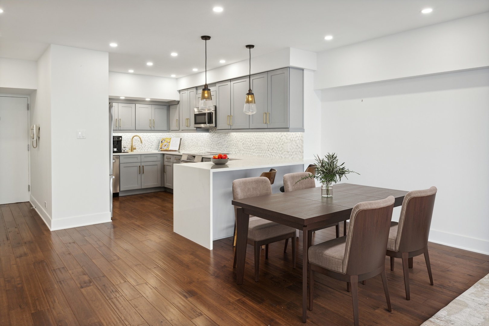 175 East Delaware Place, Unit 7204 Chicago, IL 60611 - Photo 6 of 30 a kitchen with a table and chairs in it