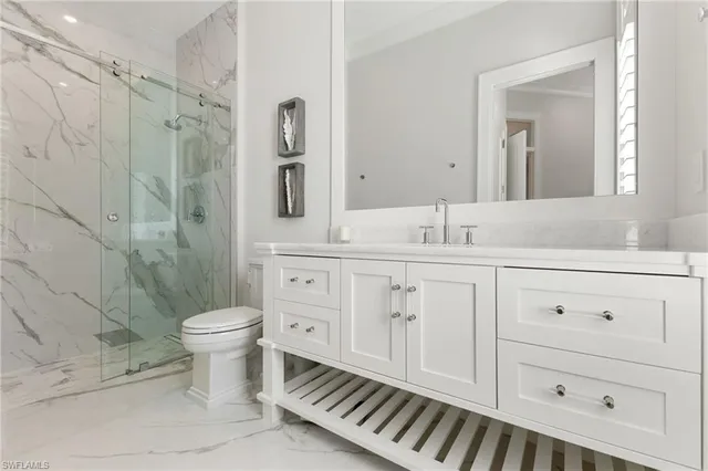 a bathroom with a sink toilet a shower and vanity