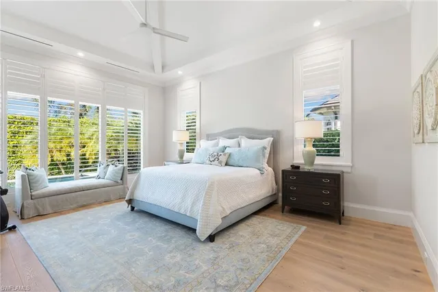 a bedroom with a bed and a large window