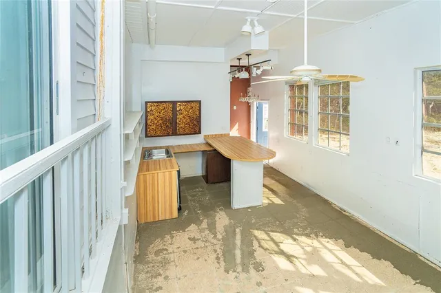 a view of a hallway with wooden floor and a window