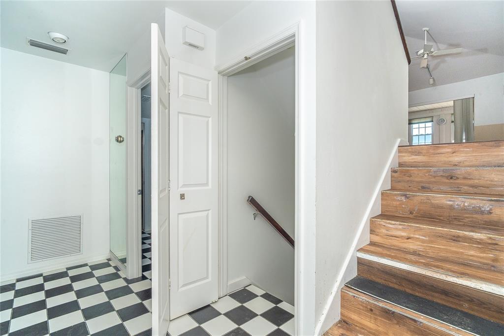 20 Palm Drive Placida, FL 33946 - Photo 24 of 46 a view of a hallway with a black white checkered floor and a white cabinet