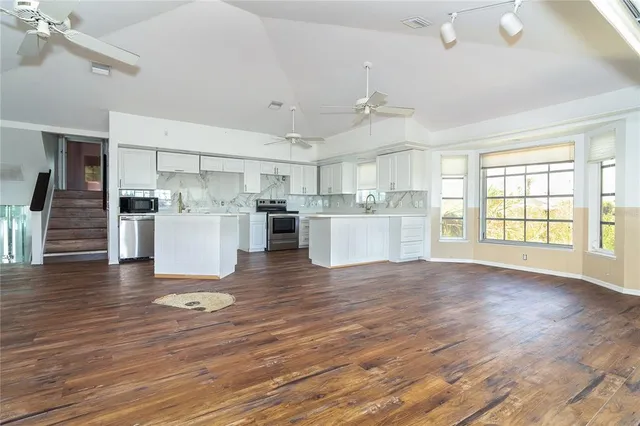 a view of a kitchen with wooden floor